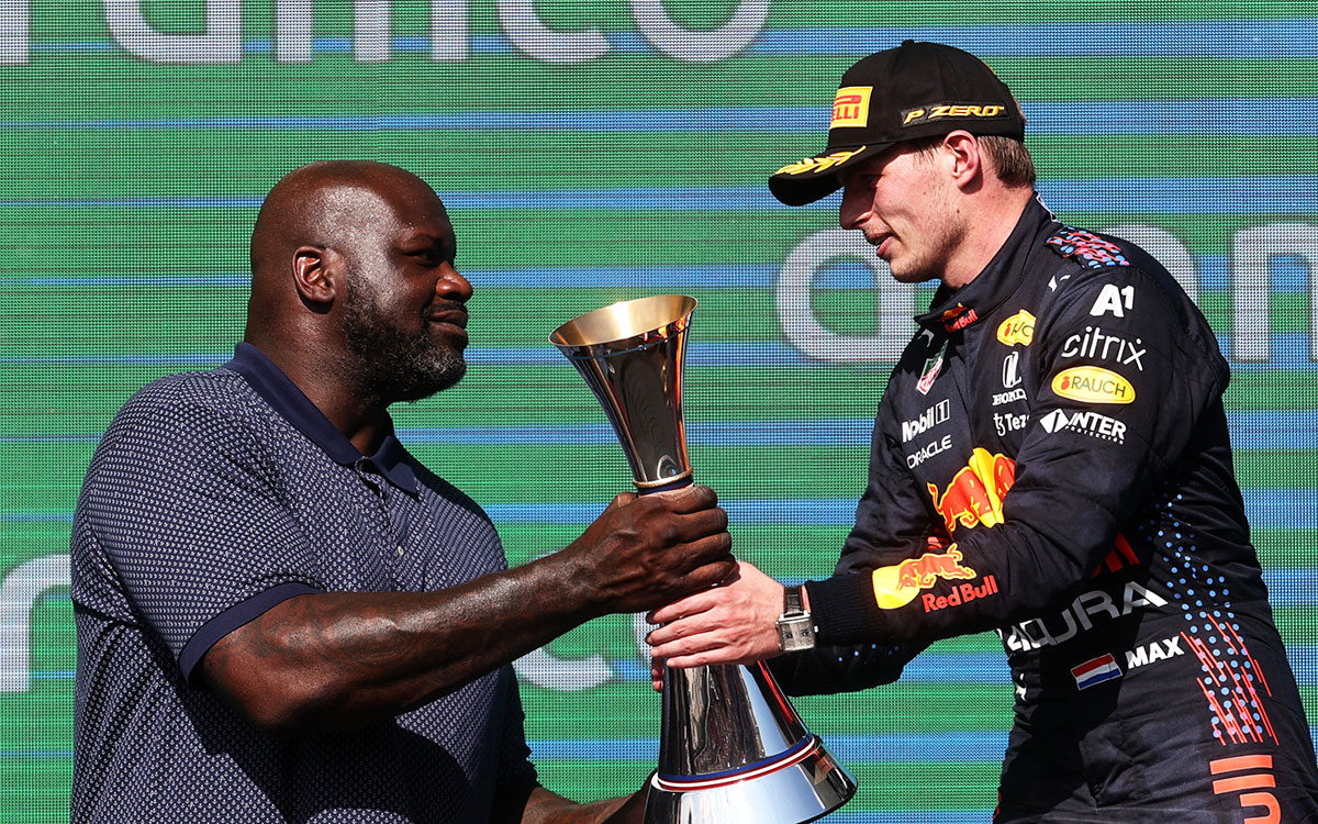 2021年F1美国大奖赛正赛,从NBA前明星球员沙奎尔·奥尼尔手中接过冠军奖杯的红牛车手维斯塔潘