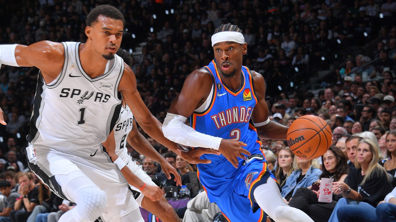 Shai Gilgeous-Alexander handles the ball against Victor Wembanyama in the Thunder–Spurs opener on October 20, 2026; NBA match photo.