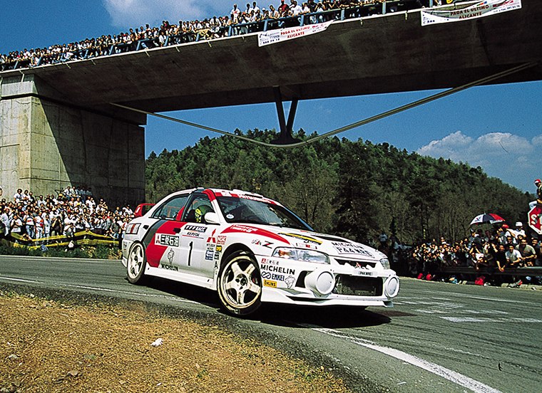 Tommi Mäkinen driving the No. 1 Mitsubishi Lancer Evolution IV on asphalt, from the official 1997 archive; the specific round is unconfirmed