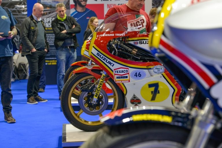 A display of Suzuki championship-winning racing bikes, pictured in a preview of the 2022 London Motorcycle Show; the No. 7 RG500 and other display bikes are in the foreground